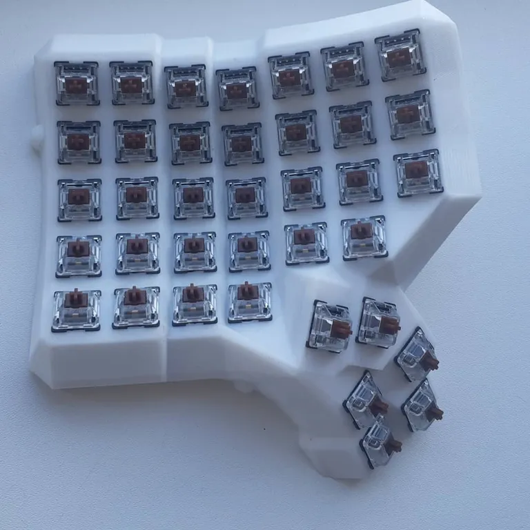 Kailh Brown switches pressed into every socket of the printed half, no caps on yet